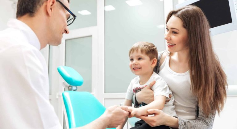 mother-and-little-son-visiting-dentist-PFXEUKE-min-scaled